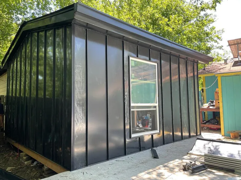Black standing seam metal wall panels for Roof Inspection in El Campo