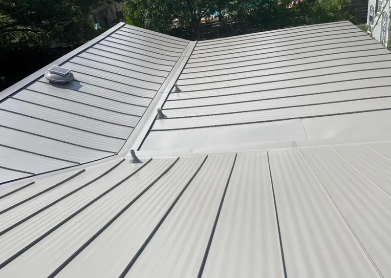 Solar attic fan installed on a metal roof for Roof Ventilation in El Campo
